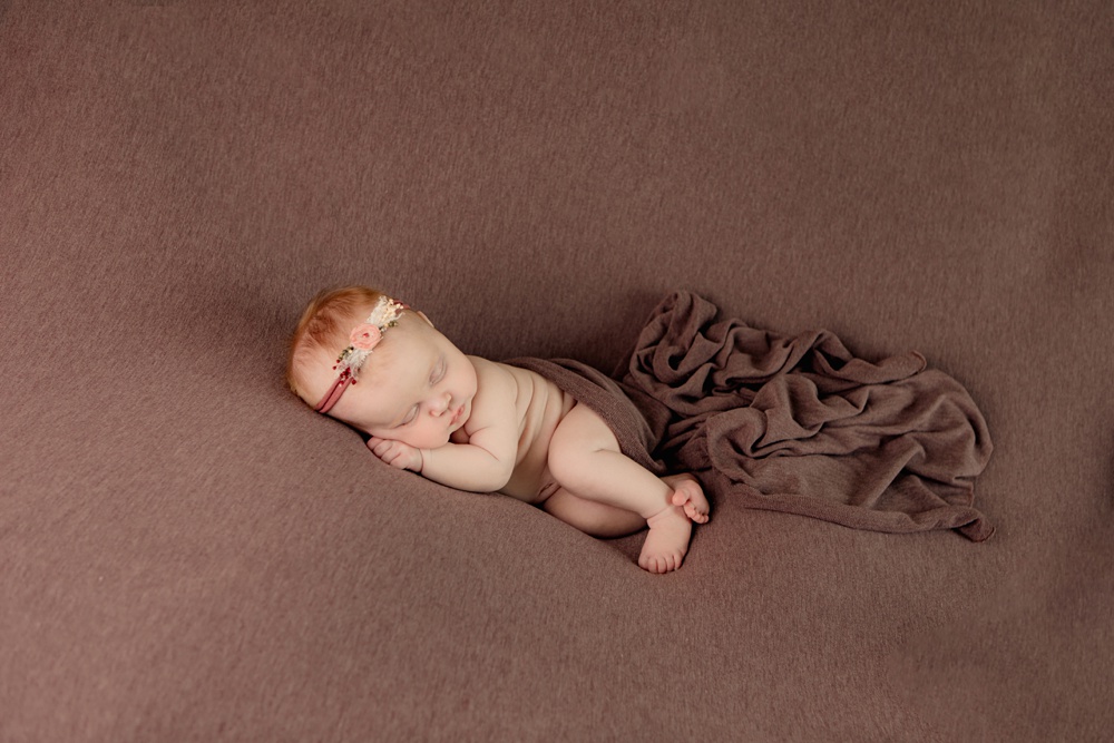 Side sleeping pose for Everly while she rests during her portrait session.