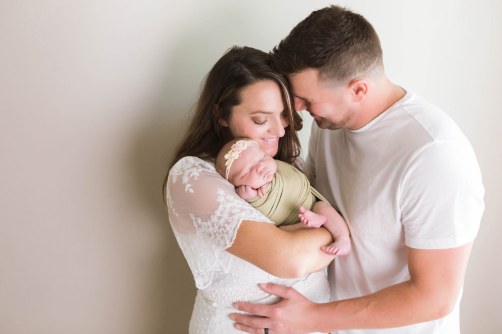 Father, Mother and baby girl at newborn photo shoot